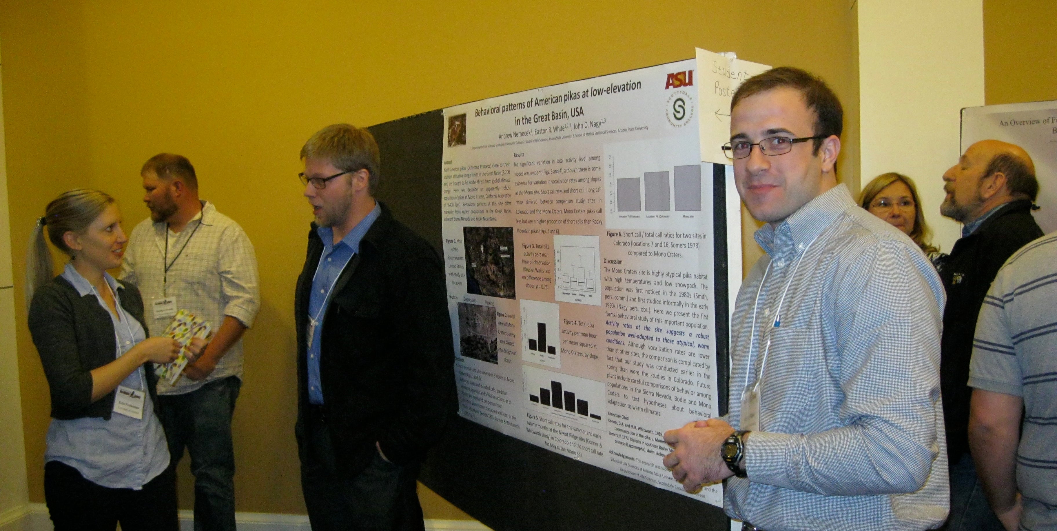 Andrew Nemecek (left) and Easton White (foreground) discuss their poster